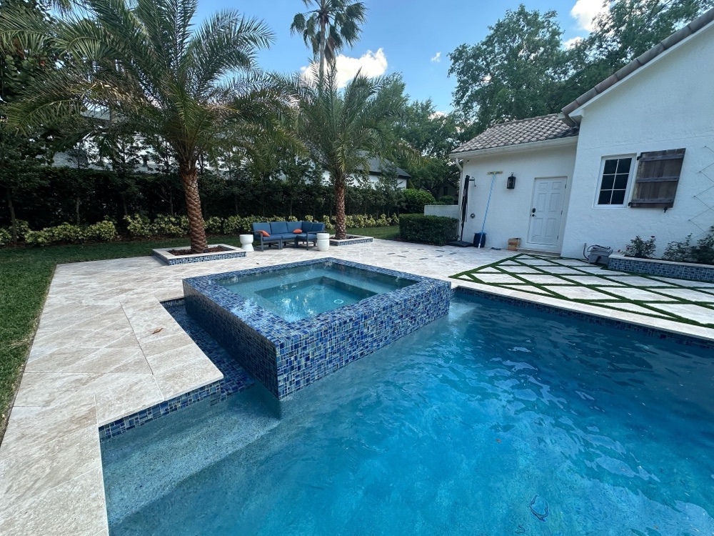 Brick patio to travertine deck + raised spa — after, view 1