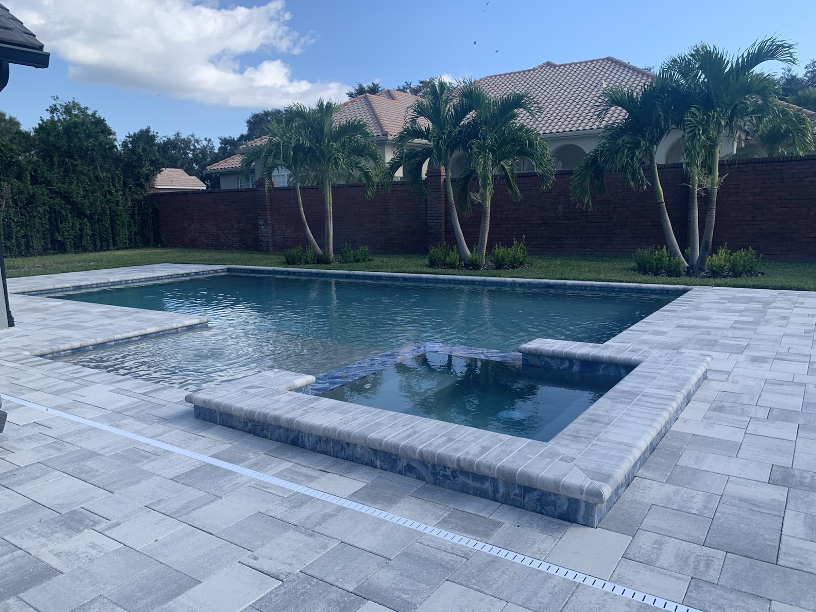 Renovated pool with new water-feature scuppers and in-deck loungers